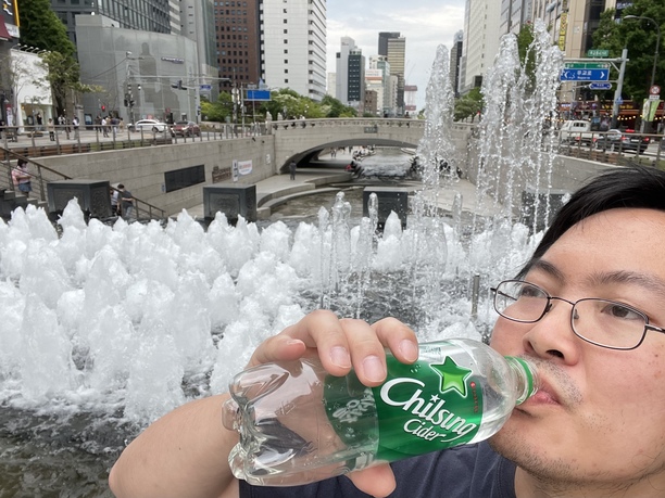 drinking cider and posing at Cheonggyecheon