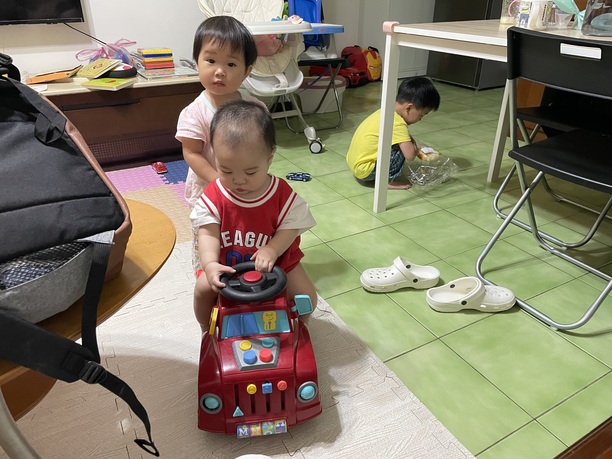 older cousin pushing baby Joseph around