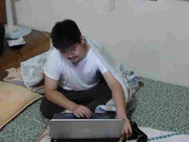 My brother uploading photos from his DSLR to his laptop