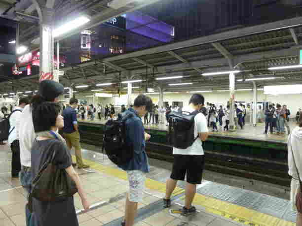 People standing in lines waiting for the train